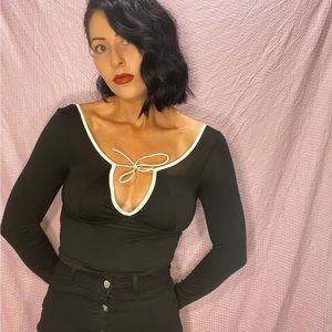 Cropped black satiny top with white lining and tie detail